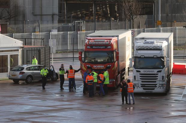 Lorry drivers and officials talk at the DEARA site near Belfast Port (Liam McBurney/PA)