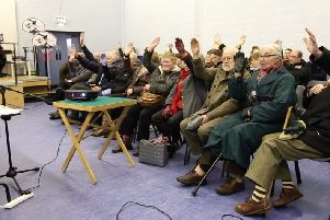 A show of hands at a public meeting in January 2015 in support of  pedestrian safety improvements and a park and ride at Ballycarry Station.